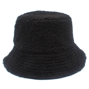 Detail of black faux lamb wool bucket hat showing plush texture and winter warmth fabric
