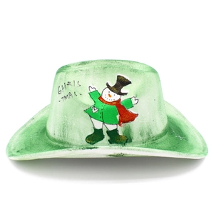 Detail of green felt cowboy hat featuring festive snowman pattern and Christmas text