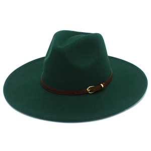 Detail of a dark green wool fedora hat with brown leather band and gold buckle