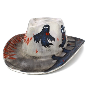 Close-up of white Halloween cowboy hat with ghost prints and red paint splatter detail
