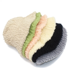 Close-up showing a variety of colorful plush fleece bucket hats for winter warmth