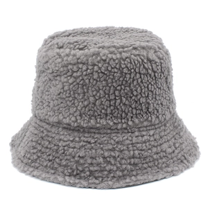 Close-up of thick dark grey faux sherpa bucket hat showing curly fleece texture and soft fabric