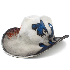 Detail of vintage cowboy hat with blue glitter ghost motifs and red spray textures
