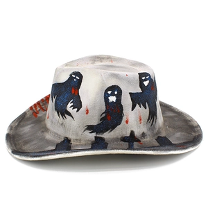 Detail of Halloween cowboy hat with blue glitter ghosts and red blood splatter effects