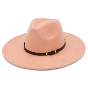 Detail of pink wool fedora hat featuring a brown leather band and gold metal buckle