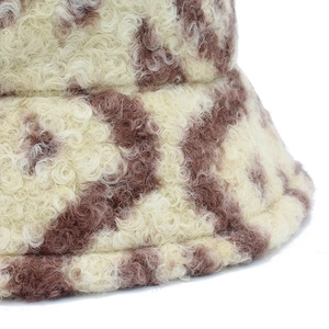 Detailed macro view of soft plaid lamb wool texture on beige and brown bucket hat