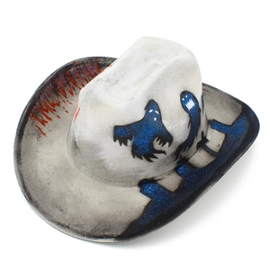 Detail of white cowboy hat with blue glitter ghost and red blood stains for Halloween