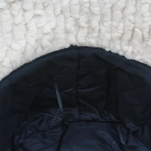 Detail of lamb wool bucket hat with black quilted lining and adjustable inner drawstring