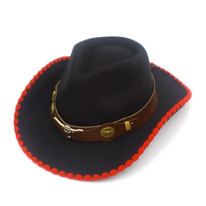 Detail of western cowboy hat featuring bull skull metal emblem and red stitched brim