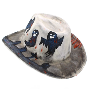 Detail of spooky ghost pattern with red blood splatter and blue glitter on white cowboy hat