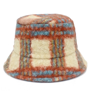 Close-up of thick checkered plush bucket hat showing fuzzy wool texture and pattern