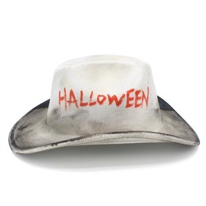 Close-up of a white distressed Halloween cowboy hat with red HALLOWEEN artistic text