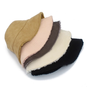 Close-up of plush lamb wool bucket hats in five colors with soft suede finish