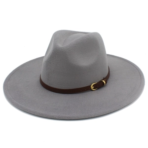 Close-up of light gray fedora hat featuring a brown leather band and gold buckle detail
