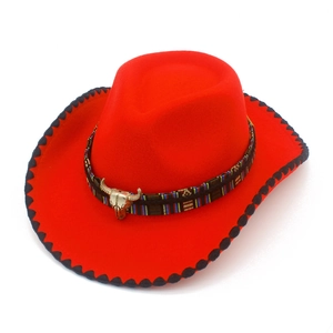 Detailed view of red felt cowboy hat with ethnic woven band and bronze bull skull pendant