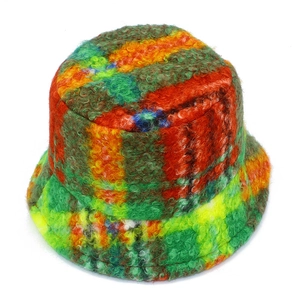 Detailed macro view of multi-color plaid fuzzy bucket hat with thick wool texture