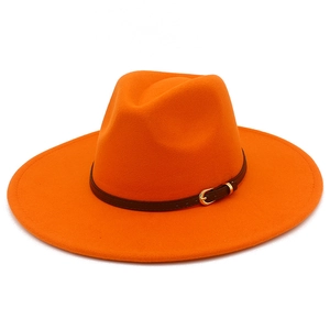 Detail of bright orange wool fedora hat featuring a brown faux leather belt with gold buckle