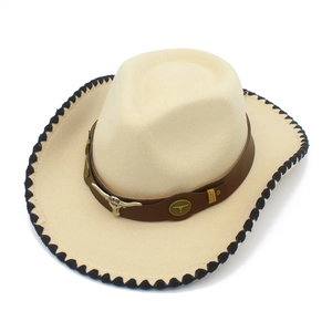 Detail of western cowboy hat featuring leather band with metal bull head and wave stitched edge