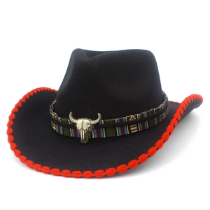 Western black felt cowboy hat with red trim, ethnic ribbon, and bull skull pendant
