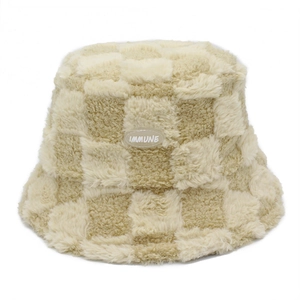 Beige checkerboard faux fur bucket hat with IMMUNE tag for winter warmth and style