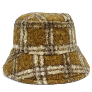 Close-up of yellow plaid plush bucket hat showing wool-like texture and warm checkered fabric