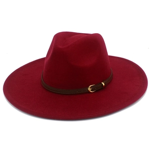 Detail of burgundy wool fedora hat featuring a brown leather band and gold buckle