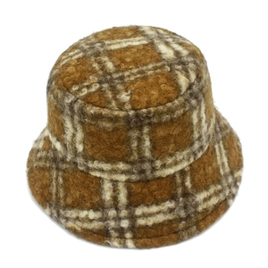 Detailed texture of thick plaid wool blend fabric on a warm winter bucket hat