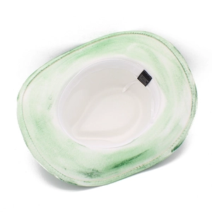 Detail of white wide brim hat showing 65% cotton fabric texture and green dye effect