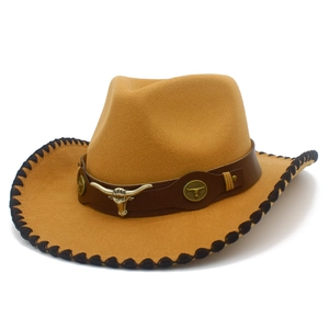 Detail of western cowboy hat with a bull head metal logo and braided edge stitching