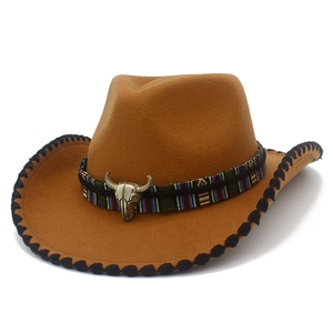 Detail of western brown felt hat featuring ethnic woven band and vintage bull skull ornament