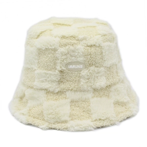 Creamy white plush bucket hat with checkerboard pattern and IMMUNE logo for winter