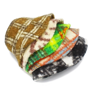 Detail view of assorted warm wool bucket hats featuring plaid, marble, and cow patterns