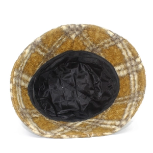 Detail view of plaid sherpa bucket hat featuring soft yellow fleece and quilted black lining