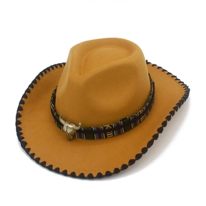Close-up of khaki western felt hat featuring bull head metal buckle and tribal band