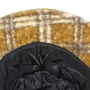 Detail view of plaid faux shearling bucket hat with adjustable inner lining drawstring