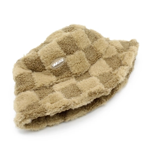 Detail of checkered sherpa bucket hat featuring a plush texture and embroidered Immune patch