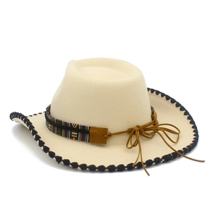 Detail of cream western felt hat with ethnic patterned band and decorative bull head
