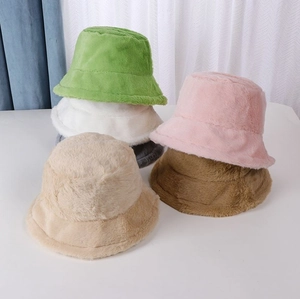 Detail showing various colors of plush faux fur bucket hats with soft texture