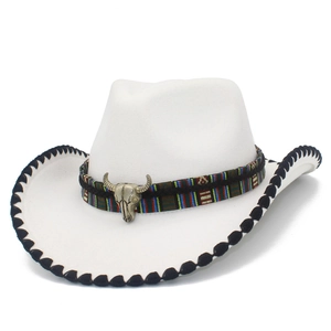 Detail of white felt cowboy hat featuring ethnic woven band and vintage bull head ornament