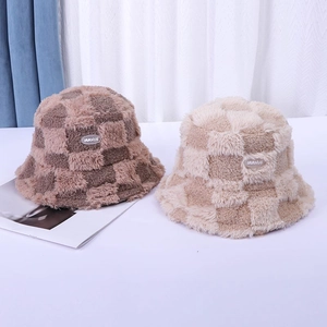 Detailed view of plush checkerboard bucket hats with soft faux fur and brand label patch