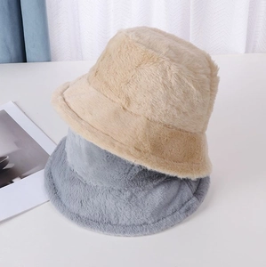 Close-up detail of khaki and grey plush faux fur bucket hats for winter warmth