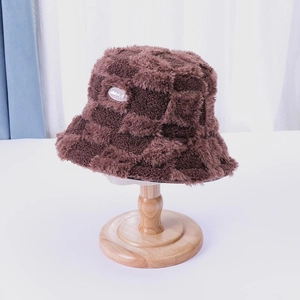 Furry checkerboard fisherman hat in dark brown with soft plush texture and logo detail