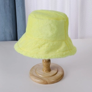 Detailed texture of fluorescent yellow faux fur bucket hat on a wooden stand