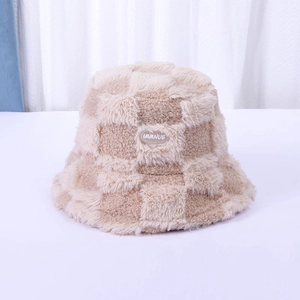 Detailed macro view of the fluffy checkerboard pattern plush winter bucket hat texture