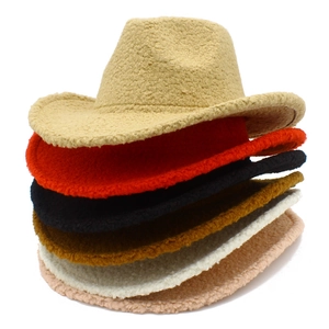 Detailed stack of plush teddy fleece cowboy hats in various vibrant colors for winter