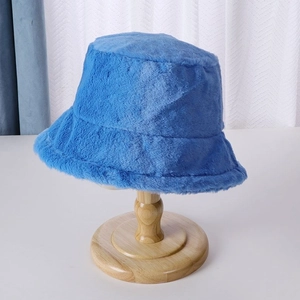 Detailed texture of blue plush bucket hat on wooden stand for winter warmth