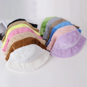 Detailed overhead view of multiple plush bucket hats in diverse colors for winter warmth
