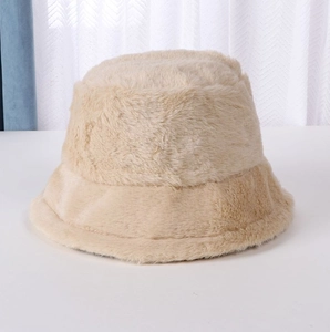 Close-up of soft beige faux fur bucket hat showing the plush texture and warm material