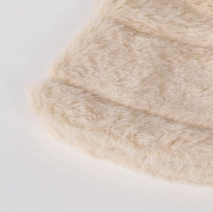 Detailed close-up of soft off-white faux fur texture on a warm winter bucket hat