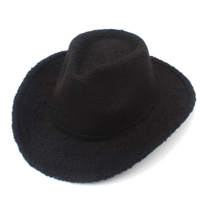 Detail shot of the matte black faux shearling texture on this stylish Western cowboy hat